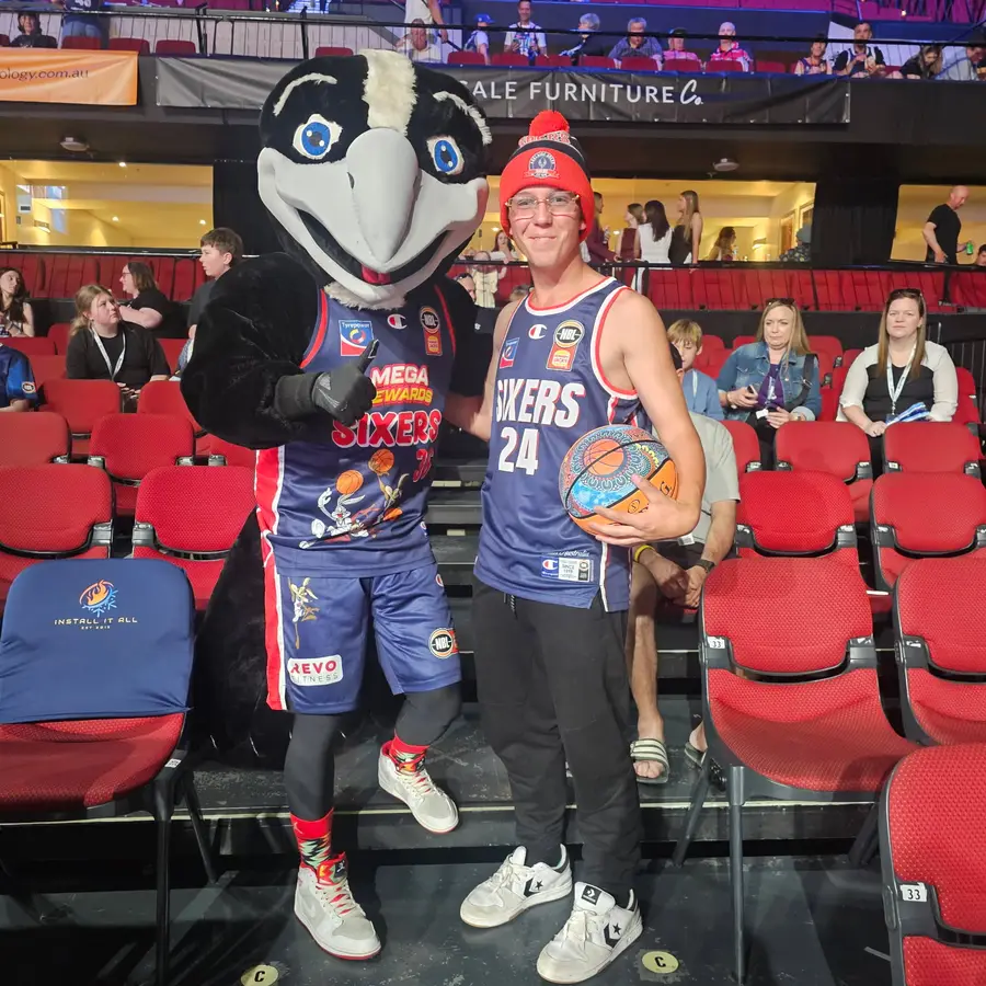NDIS participant at an Adelaide 36ers basketball game with the team mascot